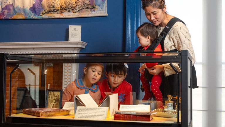 Mother and her children look at a collection display